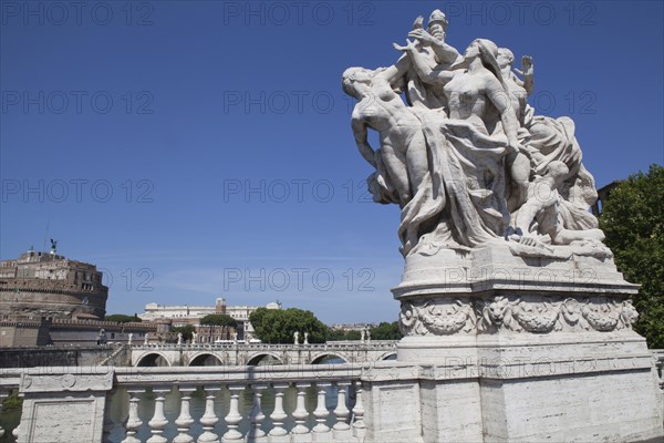 Italy, Lazio, Rome, Statue on the Ponte Vittorio Emanuele II with Castel Sant Angelo in the background. Photo : Bennett Dean