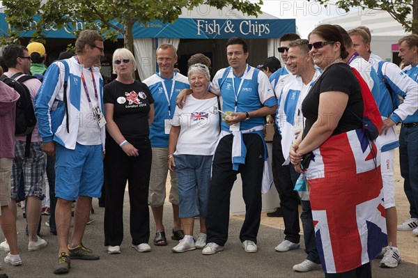 England, London, Stratford Olympic Park Group of Team GB supporters having their photographs taken with competitors from Finland. Photo : Adina Tovy - Amsel