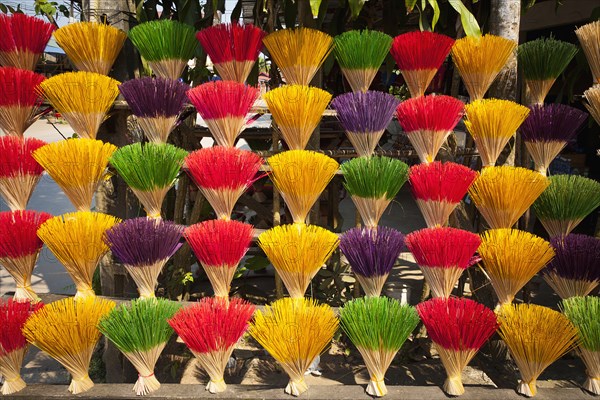 Vietnam, Thuy Zuan Hat village, Colourful bundles of incense sticks for sale. Photo : Mel Longhurst