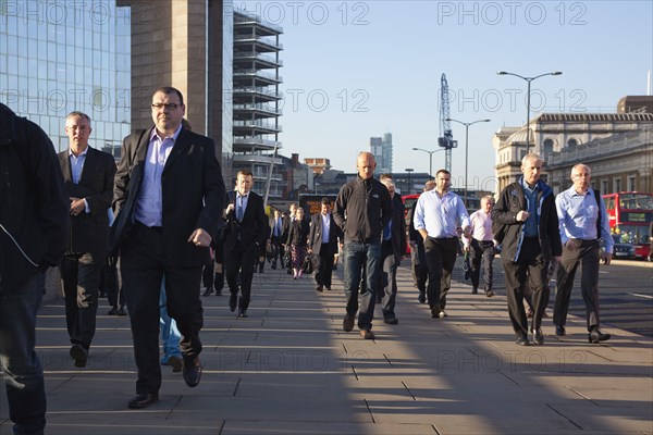 England, London, Early morning commuters crossing London Bridge towards the City Financial district. Photo : Stephen Rafferty