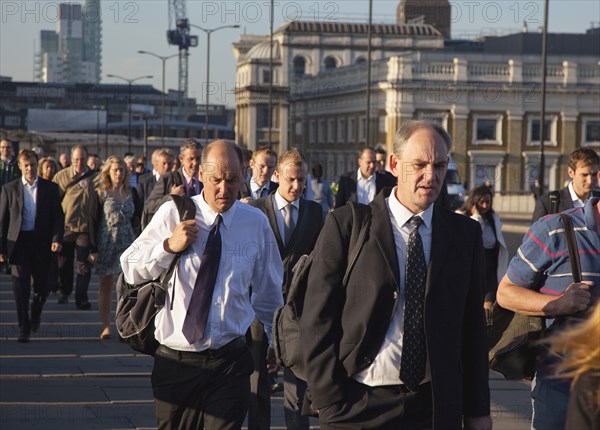 England, London, Early morning commuters crossing London Bridge towards the City Financial district. Photo : Stephen Rafferty