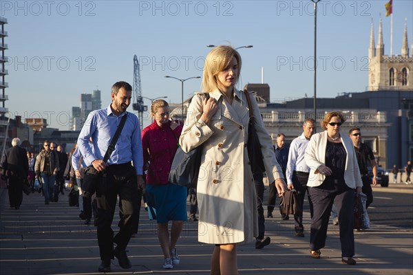 England, London, Early morning commuters crossing London Bridge towards the City Financial district. Photo : Stephen Rafferty