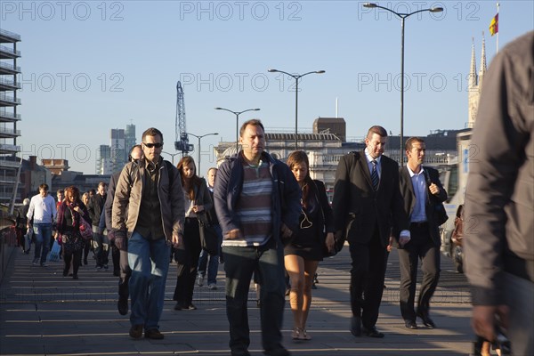 England, London, Early morning commuters crossing London Bridge towards the City Financial district. Photo : Stephen Rafferty