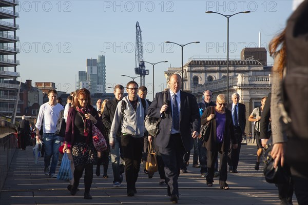 England, London, Early morning commuters crossing London Bridge towards the City Financial district. Photo : Stephen Rafferty