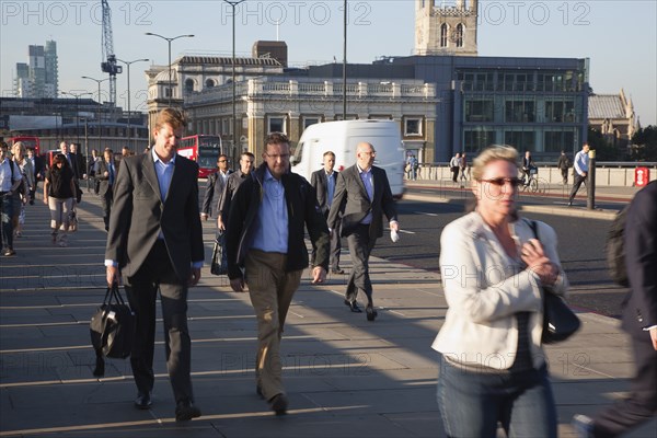 England, London, Early morning commuters crossing London Bridge towards the City Financial district. Photo : Stephen Rafferty