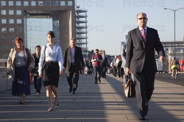 England, London, Early morning commuters crossing London Bridge towards the City Financial district. Photo : Stephen Rafferty