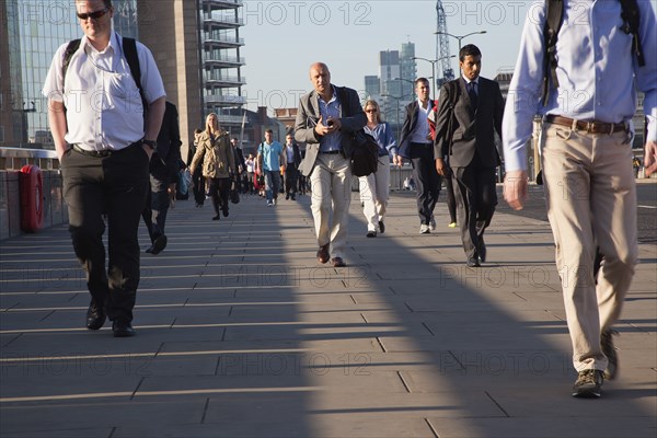 England, London, Early morning commuters crossing London Bridge towards the City Financial district. Photo : Stephen Rafferty