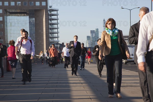 England, London, Early morning commuters crossing London Bridge towards the City Financial district. Photo : Stephen Rafferty