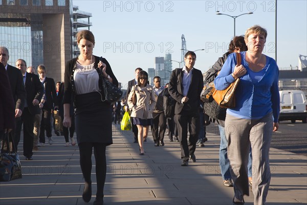 England, London, Early morning commuters crossing London Bridge towards the City Financial district. Photo : Stephen Rafferty