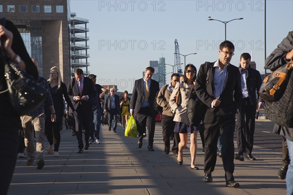 England, London, Early morning commuters crossing London Bridge towards the City Financial district. Photo : Stephen Rafferty