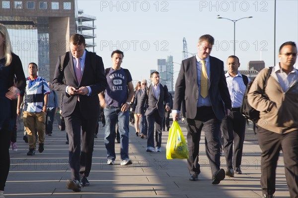 England, London, Early morning commuters crossing London Bridge towards the City Financial district. Photo : Stephen Rafferty