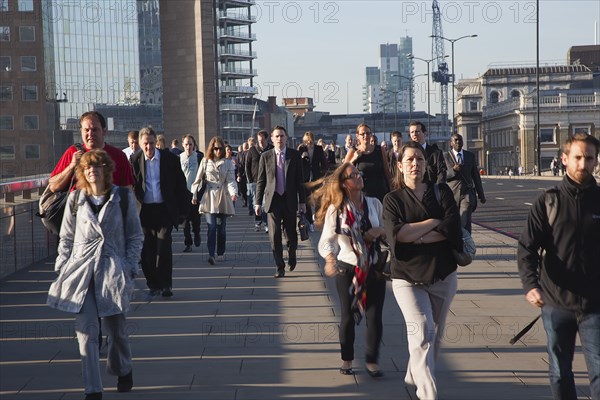 England, London, Early morning commuters crossing London Bridge towards the City Financial district. Photo : Stephen Rafferty