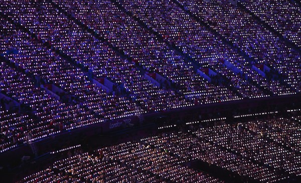 England, London, Stratford Olympic games closing ceremony LED paddles visible in the darkness. Photo : Sean Aidan