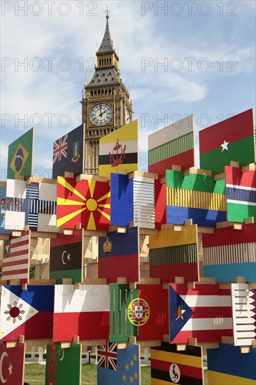 England, London, Parliament Square Sculpture containing flags of competing Olympic nations with Big Ben behind. Photo : Sean Aidan