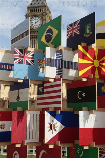 England, London, Parliament Square Sculpture containing flags of competing Olympic nations with Big Ben behind. Photo : Sean Aidan