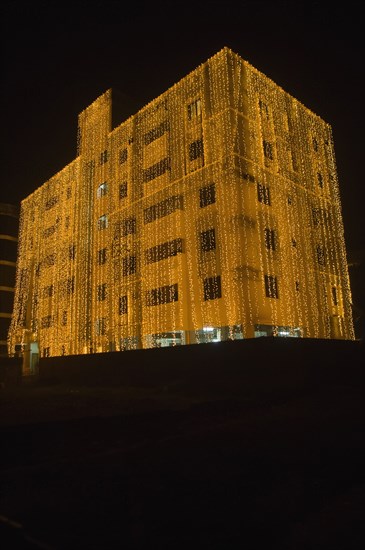 Bangladesh, Dhaka, Gulshan Apartment block at night lit up for a wedding with strings of fairy lights cascading over the side. 
Photo Nic I Anson / Eye Ubiquitous