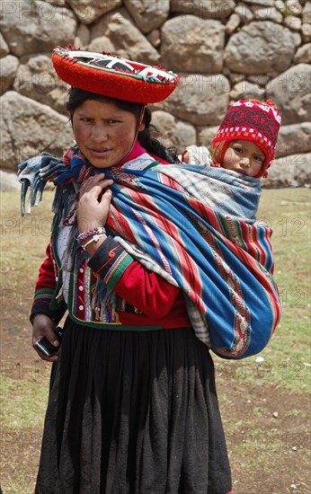Peru, Indigenous People, Woman with baby in traditional dress. 
Photo Richard Rickard / Eye Ubiquitous