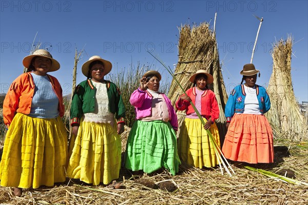 Peru, Puno, Lake Titicaca Women in colorful clothing on Grass Island. . 
Photo Richard Rickard / Eye Ubiquitous