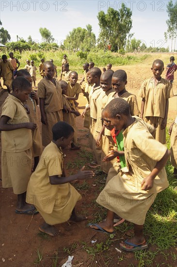 Burundi, Cibitoke Province, Buganda, Ruhagurika Primary School girls dancing during their playtime outside Catch-Up Class in Buganda Commune. Catch up classes were established by Concern Worldwide across a number of schools to provide a second chance for children who had dropped out. 
Photo Nic I Anson / Eye Ubiquitous