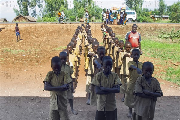 Burundi, Cibitoke Province, Buganda, Ruhagurika Primary Students lining up ready to go into their Catch-Up Class. Catch up classes were established by Concern Worldwide across a number of schools in Cibitoke to provide a second chance for children who had previously dropped out of school. 
Photo Nic I Anson / Eye Ubiquitous