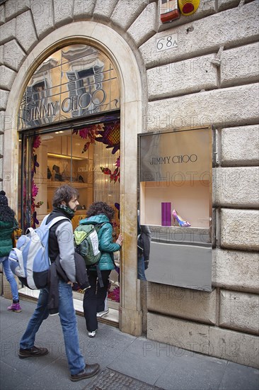 Italy, Lazio, Rome, Via del Condotti Tourists looking at shoe display in the Jimmy Choo shop. 
Photo Stephen Rafferty / Eye Ubiquitous