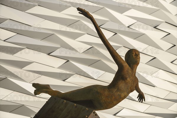 Ireland, North, Belfast, Titanic Quarter, Titanic Belfast Visitor Experience, 'Titanica' sculpture by Rowan Gillespie with section of the building in the background. 
Photo Hugh Rooney