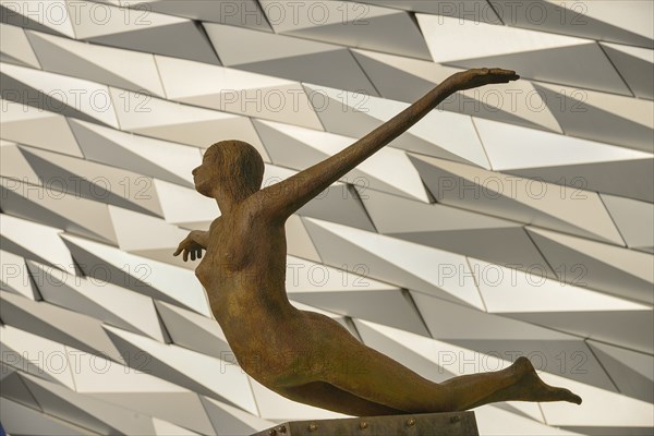 Ireland, North, Belfast, Titanic Quarter  Titanic Belfast Visitor Experience  Titanica sculpture by Rowan Gillespie with section of the building in the background.