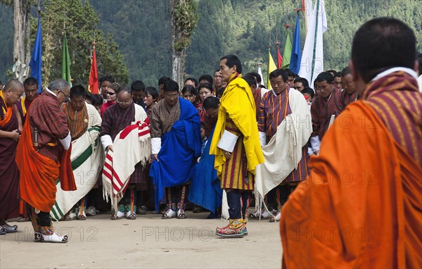 Bhutan, Gangtey Gompa, 4th King of Bhutan leaving after inauguration of new temple; surrounded by ministers, media and police. 
Photo Nic I'Anson