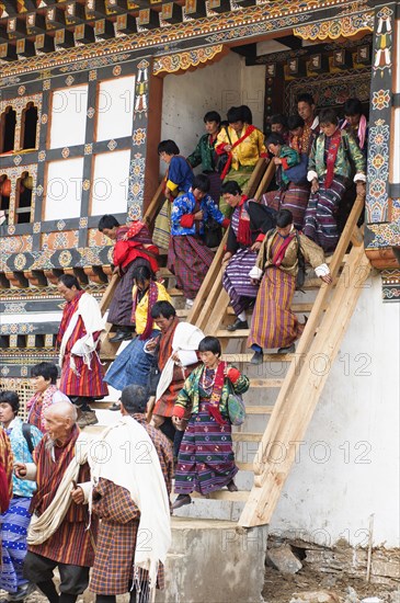 Bhutan, Gangtey Gompa, Tsecchu festival crowds descending temple steps dressed in their best clothes. 
Photo Nic I'Anson