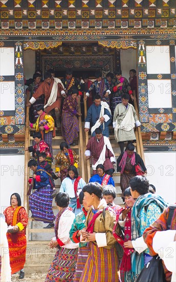 Bhutan, Gangtey Gompa, Tsecchu festival crowds descending temple steps dressed in their best clothes. 
Photo Nic I'Anson