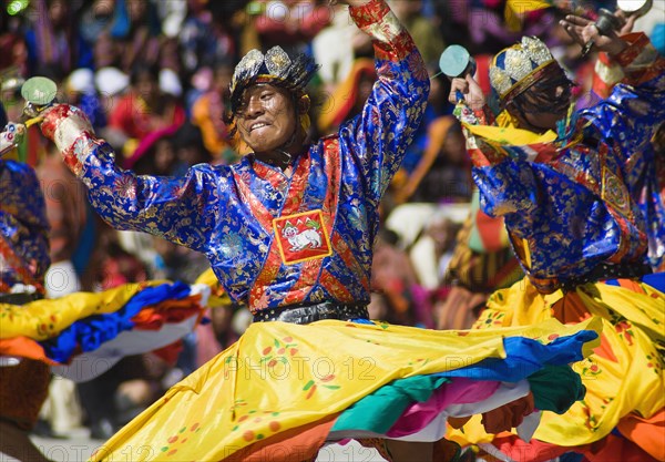 Bhutan, Thimpu Dzong, Dancers in the courtyard during festival. 
Photo Nic I'Anson