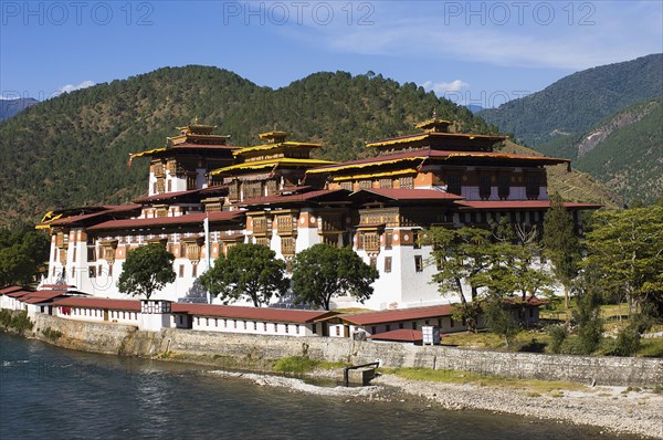 Bhutan, Punakha, Punakha Dzong, administrative centre of the region and former capital housing scared relics, beside the Mo Chhu river. 
Photo Nic I'Anson