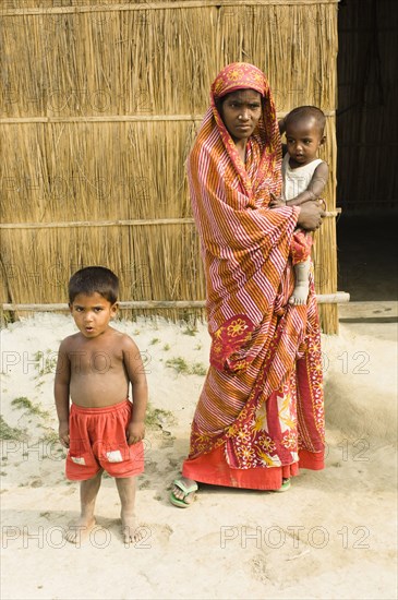 Bangladesh, Dhaka Division, Tangail Sadar Upazila, Mother and children on the impoverished chars, beside the Brahmaputra river. 
Photo Nic I'Anson