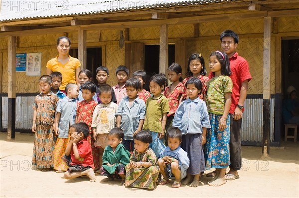 Bangladesh, Chittagong Division, Bandarban, Students and teachers stood outside a small primary school in a remote area of the Chitagong Hill tracts. 
Photo Nic I'Anson