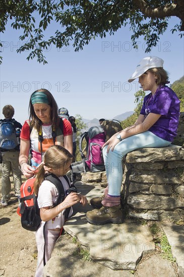 Nepal, Himalayas, Pokhara, Western family with children resting during trek in Nepali Himalayan hills near Pokhara. 
Photo NIc I Anson