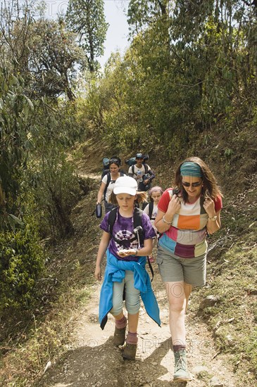 Nepal, Himalayas, Pokhara, Western family with children trekking in Nepali Himalayan hills near Pokhara.