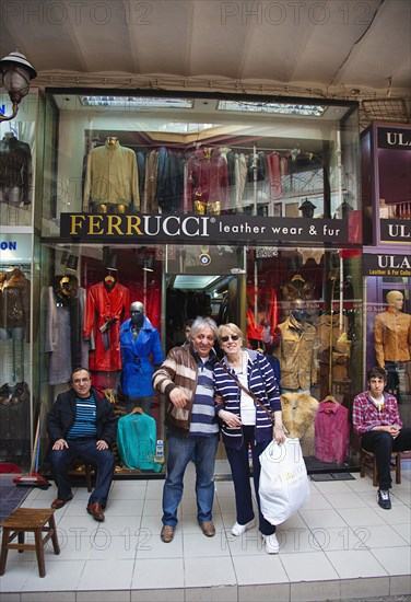 Turkey, Istanbul, Fatih, Sultanahmet, Kapalicarsi, Customer and owner of Ferrucci's Leather Wear and Fur Store in the Grand Bazaar. 
Photo Stephen Rafferty
