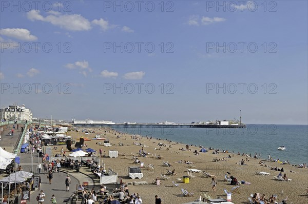 View along the Brighton beach and beachside cafes to Pier Brighton East Sussex England