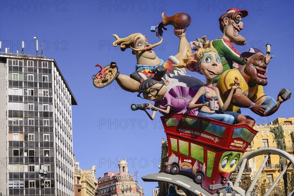 Spain, Valencia Province, Valencia, Las Fallas scene with Papier Mache figures on a Bus Turistic in Plaza Ayuntamiento during Las Fallas festival. 
Photo Hugh Rooney