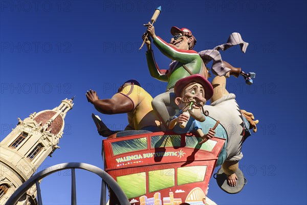 Spain, Valencia Province, Valencia, Las Fallas scene with Papier Mache figures on a Bus Turistic in Plaza Ayuntamiento during Las Fallas festival. 
Photo Hugh Rooney