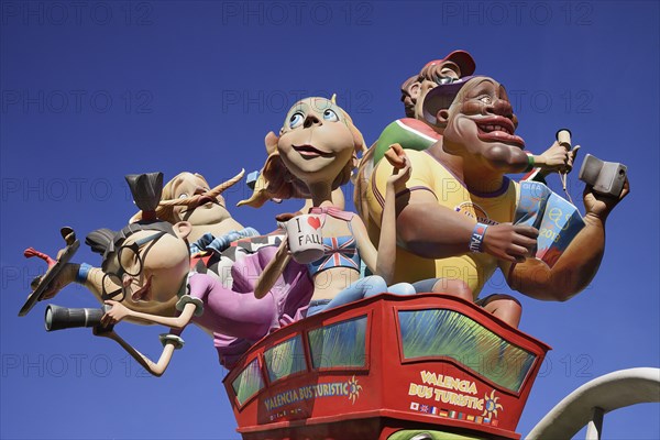 Spain, Valencia Province, Valencia, Las Fallas scene with Papier Mache figures on a Bus Turistic in Plaza Ayuntamiento during Las Fallas festival.