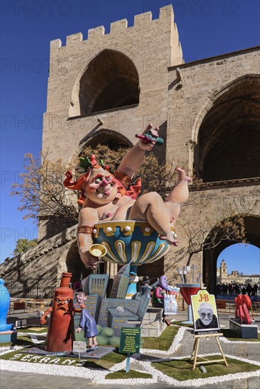 Spain, Valencia Province, Valencia, Grotesque Papier Mache figure at the Serranos Towers during Las Fallas festival. 
Photo Hugh Rooney
