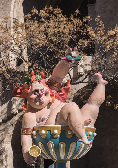 Spain, Valencia Province, Valencia, Grotesque Papier Mache figure at the Serranos Towers during Las Fallas festival. 
Photo Hugh Rooney