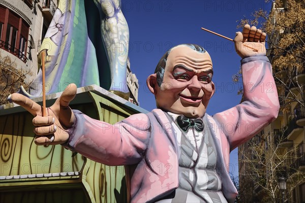 Spain, Valencia Province, Valencia, Papier Mache figure of a man in a pink jacket in the street during Las Fallas festival. 
Photo Hugh Rooney