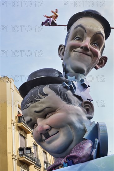 Spain, Valencia Province, Valencia, Papier Mache versions of Laurel and Hardy in the street during Las Fallas festival. 
Photo Hugh Rooney