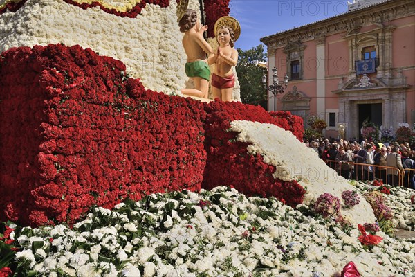 Spain, Valencia Province, Valencia, Base of the Statue of Virgen de los Desamparados, Our Lady of the Forsaken, decked out with flowers carried in the religious procession during Las Fallas festival. 
Photo Hugh Rooney