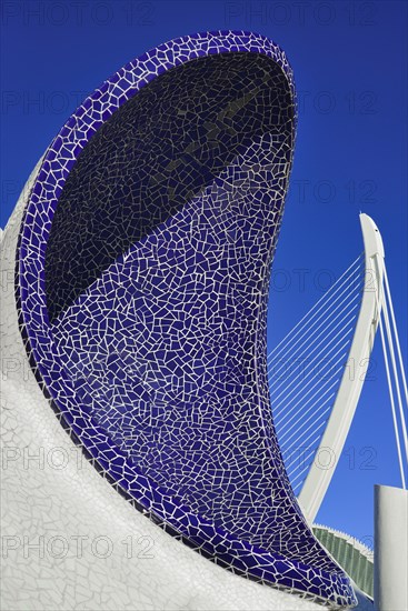 Spain, Valencia Province, Valencia, Spain, Valencia Province, Valencia, La Ciudad de las Artes y las Ciencias, City of Arts and Sciences, An arch of the Umbracle sculpture garden with El Pont de l'Assut de l'Or bridge in the background. 
Photo Hugh Rooney