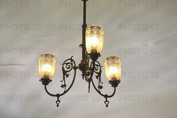 Spain, Catalonia, Barcelona, La Pedrera or Casa Mila on Passeig de Gracia, designed by Antoni Gaudi, Art Nouveau lighting in the Apartment. 
Photo Stephen Rafferty