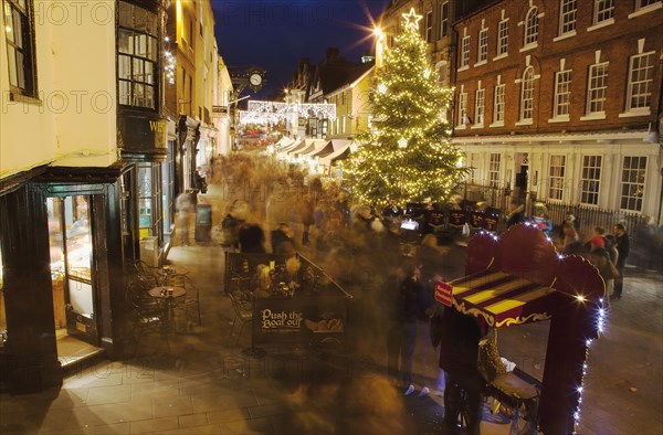 England, Hampshire, Winchester, High street decorated with Christmas tree and decorations, seen from the Buttercross.