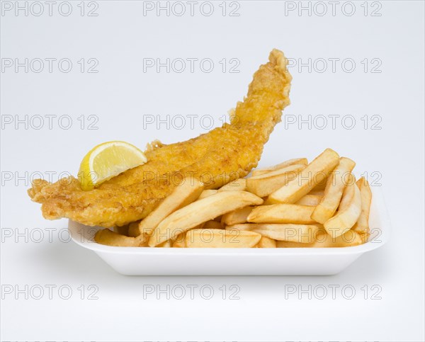 Food, Cooked, Fish, A portion of battered deep fried cod with a slice of lemon and potato chips